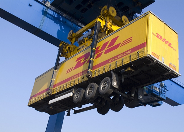Crane lifting a semi-trailer.